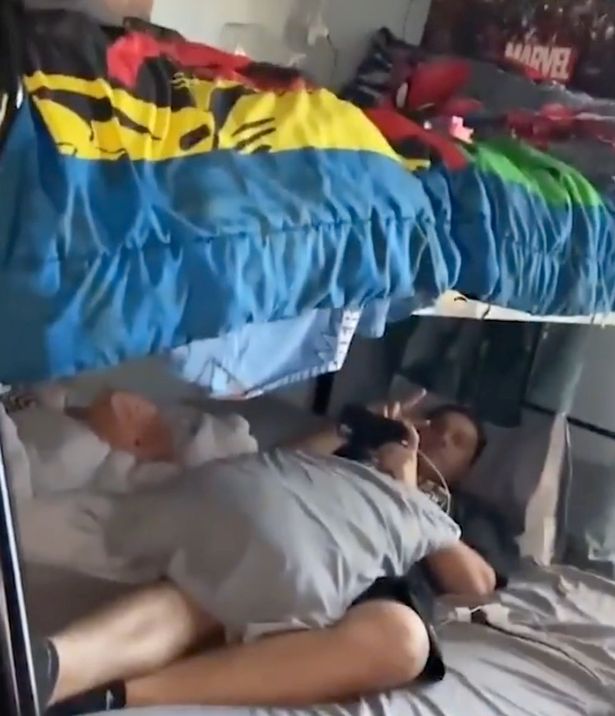 Bunk bed, with one person on the bottom bunk