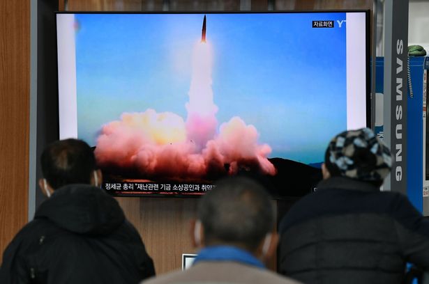 People watch a North Korean missile test on TV at a railway station in Seoul, South Korea