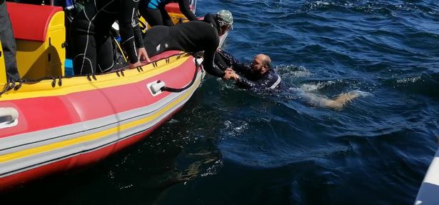 The dad was pulled out of the water to safety