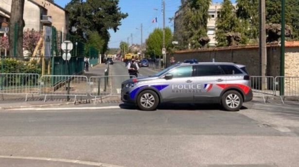 Armed police stand guard at a cordon after an officer was stabbed to death in Rambouillet