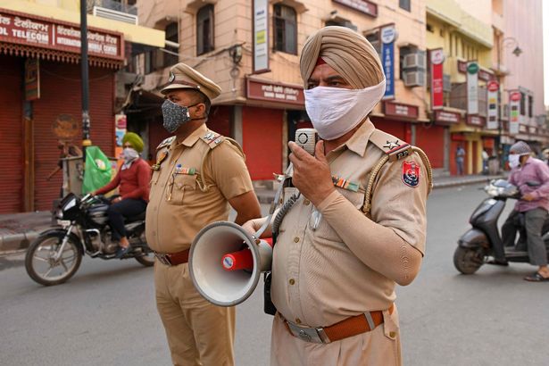 Police can be see urging the shopkeepers to close the shops before a night curfew begins after the state government's directive to curb the spread of Covid-19 coronavirus in Amritsar