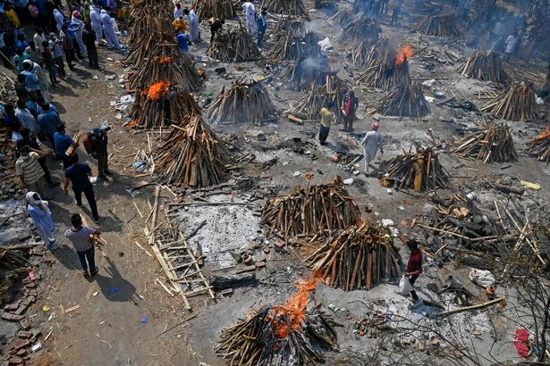 Burning funeral pyres can be seen of the patients who died of the Covid-19 coronavirus at a crematorium in New Delhi