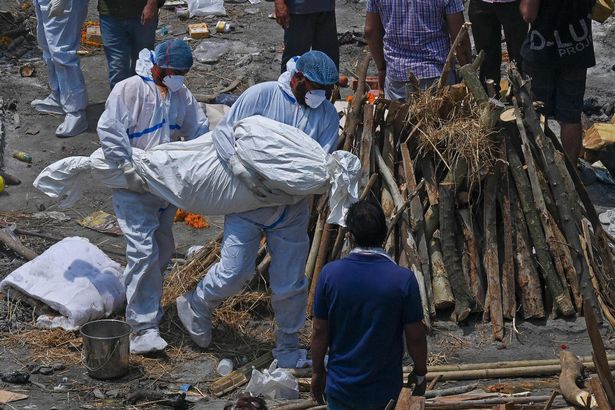 Family members and ambulance worker wearing PPE kit