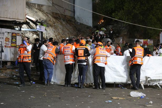 Emergency workers gather at the scene after dozens of people were killed