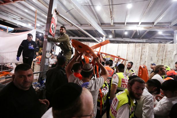 Medics and rescue workers carry stretchers at the Lag B'Omer event in Israel