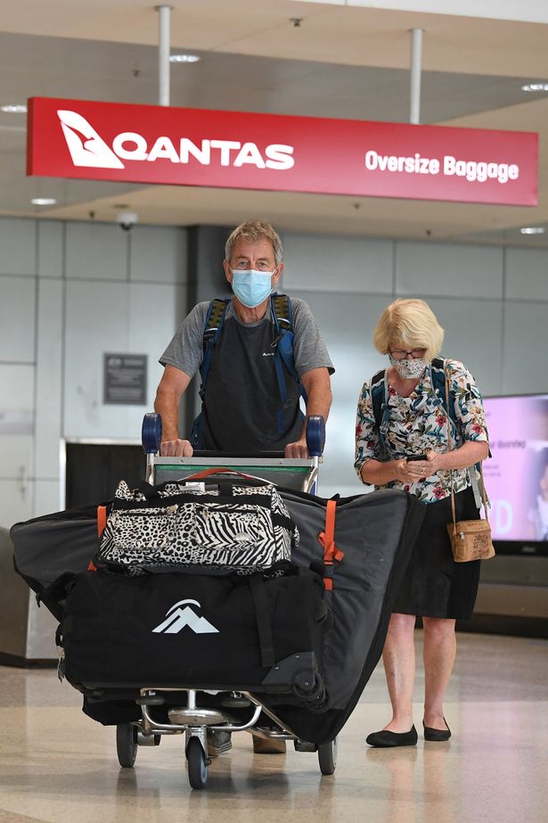 Passengers collect baggage after arriving