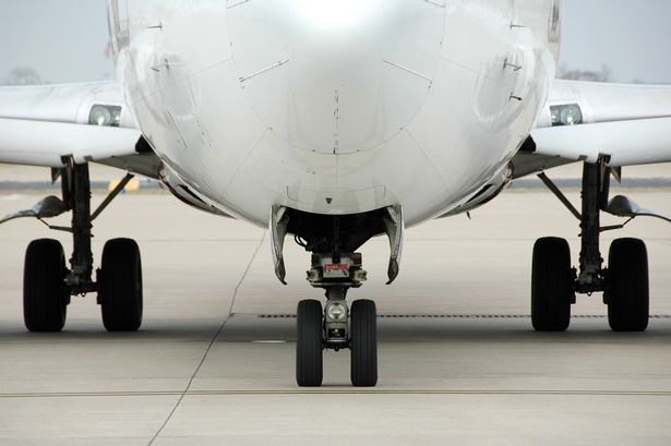 Airplane front view at the airport showing landin gear