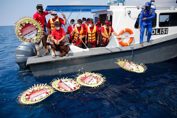 Wreathes are laid on the water