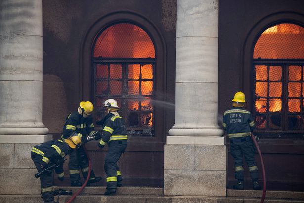 Firefighters try to extinguish a fire in the Jagger Library, at the University of Cape Town