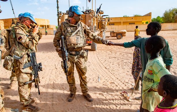 A soldier and a local greet each other with respect