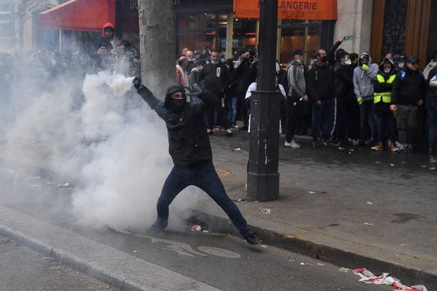 A protester throws a projectile during clashes with police at the annual May Day (Labour Day) rally in Paris