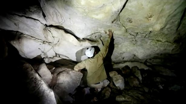 Archeologist Sergio Grosjean explores a cave where ancient handprints were found in Merida, Mexico