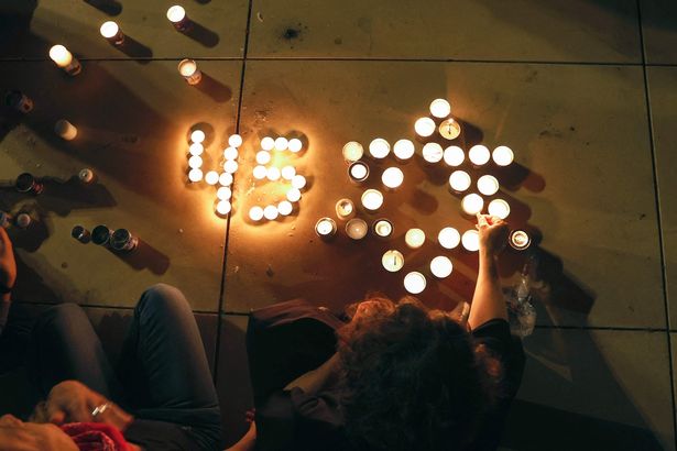 People in Tel Aviv light candles in tribute to the 45 victims of the disaster