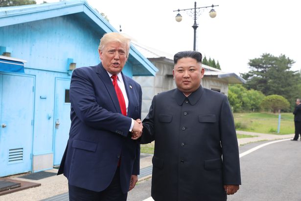 Donald Trump and Kim Jong-un shake hands at the DMZ