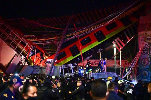 Rescue workers gather at the site of a metro train accident