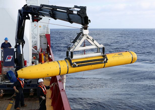 Crew aboard an Australian Defence force vessel use an underwater vehicle to look for the missing Malaysia Airlines flight