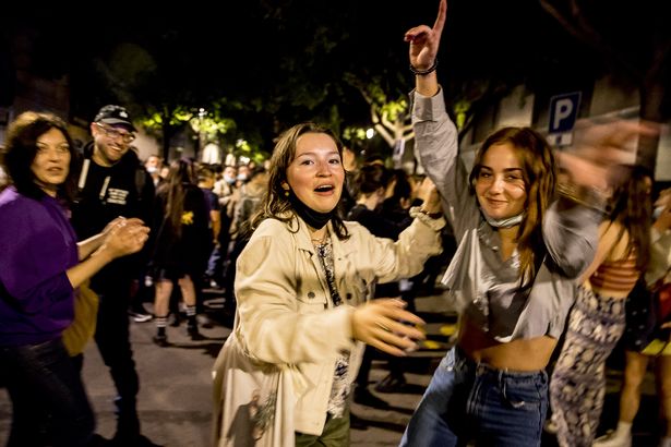 People celebrate the end of curfew