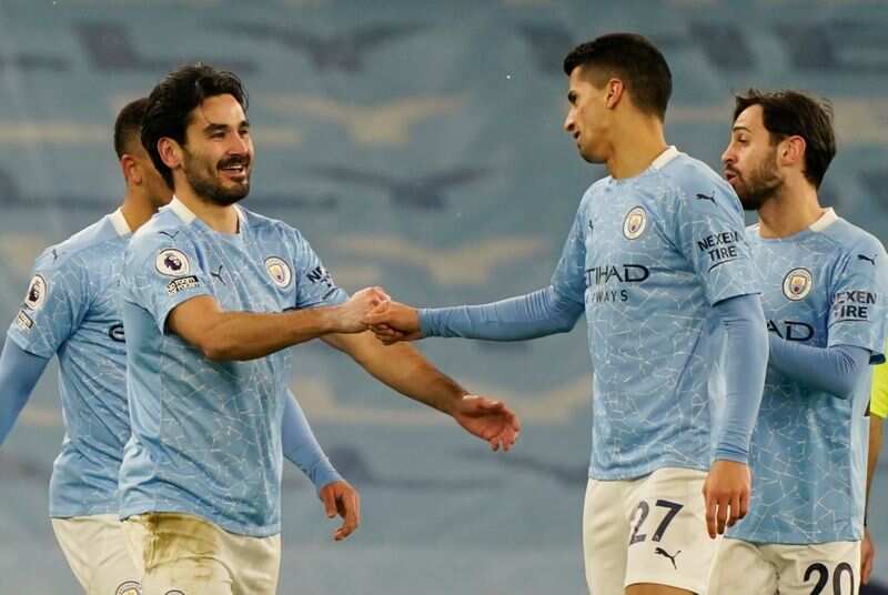 Manchester City's Ilkay Gundogan celebrates scoring their second goal with Joao Cancelo and Bernardo Silva.(Pool via REUTERS)