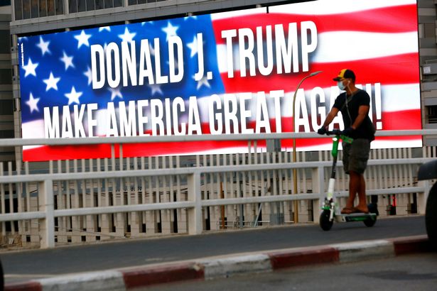 A banner supporting ex-President Donald Trump is seen on a bridge along a highway in Tel Aviv in 2020