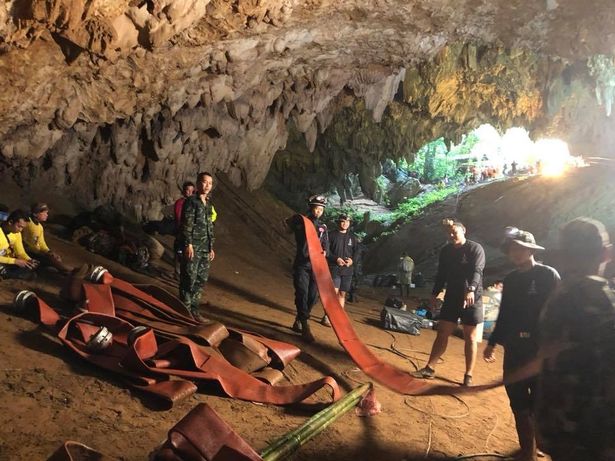 Thai Navy divers prepare equipment in the cave during the rescue mission