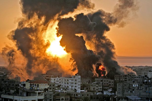 A fire rages at sunrise following an Israeli airstrike on targets in the southern Gaza strip