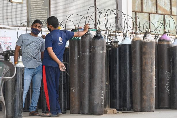 Employees refill cylinders with medical oxygen for Covid-19 coronavirus patients