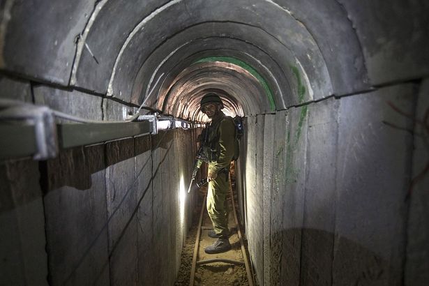 An Israeli army officer walks through a tunnel said to be used by Palestinian militants from the Gaza Strip