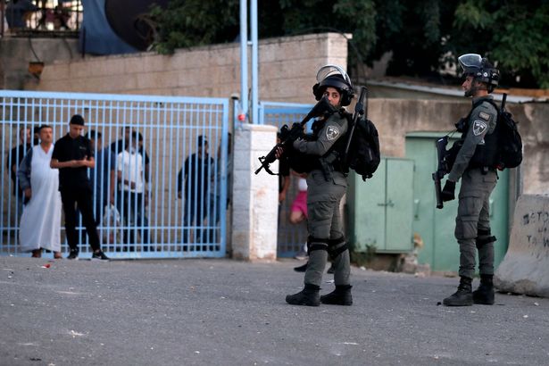 Israeli border guards stand at attention in the east Jerusalem neighbourhood of Sheikh Jarrah