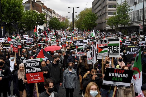 Protesters attend a rally to express solidarity with Palestine in London on Saturday