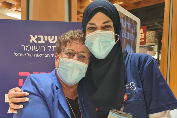 Jewish mum Miriam Peretz - who lost two of her six sons serving in the Israeli Army in conflicts with its Arab neighbours - wraps her arms around Arab-Israeli nurse Lena Ahmad