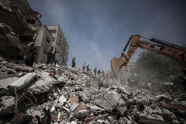 Search and rescue works continue after airstrikes by Israeli army hit buildings in al-Wehda street in Gaza City on May 16