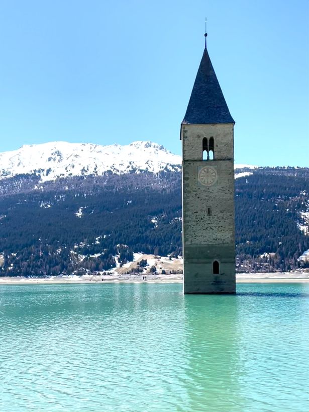 The church bell tower emerging alone from a lake