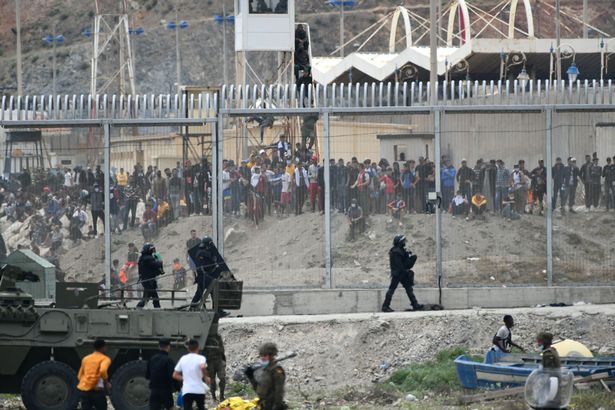 The scene at the beach of 8,000 migrants