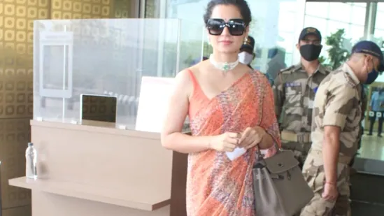 Kangana styled her airport look in the usual signature style that she sports at the airport, her hair up in a bun, big sunglasses, a delicate choker lacing her neck and earrings in her ears.(Varinder Chawla)
