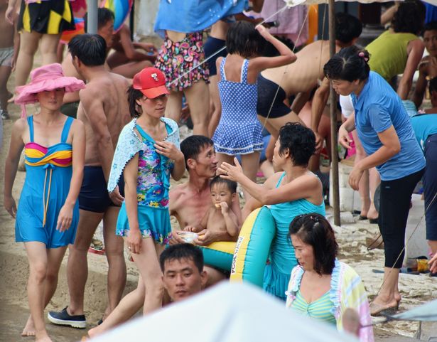 North Koreans relax during a hot, muggy summer at the beach