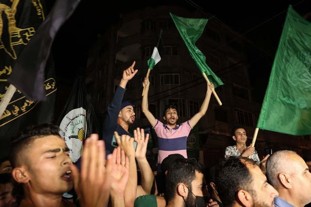 Palestinians celebrate in the streets following a ceasefire