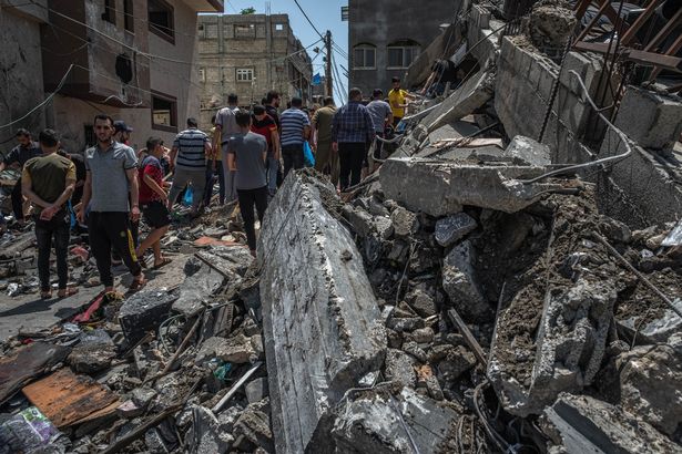 Palestinians inspect damage to buildings in Gaza City