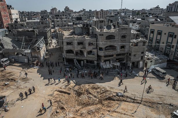 Palestinians inspect damage to buildings in Al-Saftawi street northern Gaza City