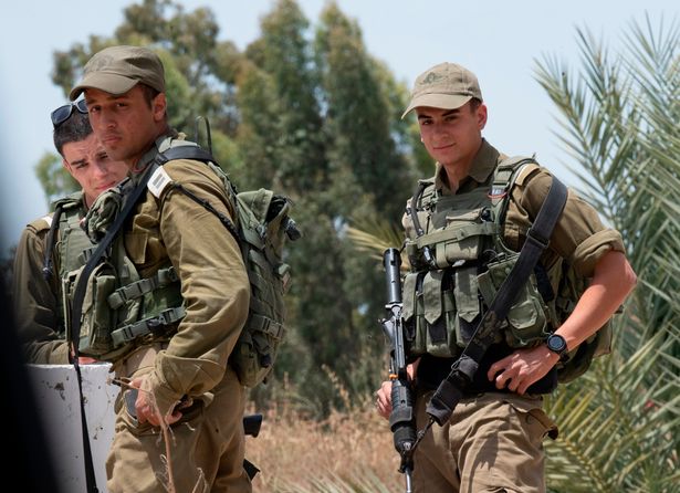 Soldiers on the border with Gaza as a ceasefire brings a halt to the killing