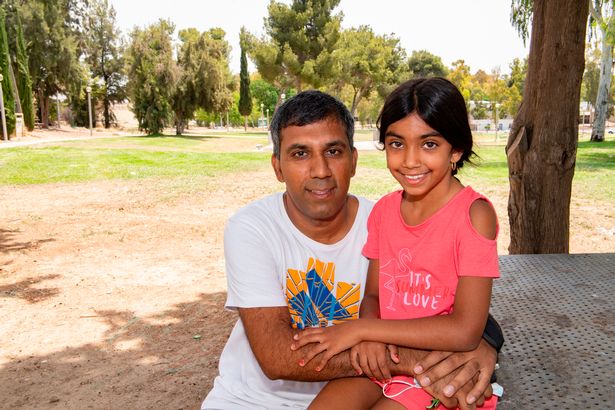 Andy Evraham with his daughter Adam just returned after she was evacuated from Sderot when fighting began