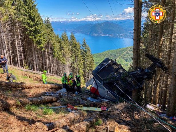 Emergency crews work at the site of the cable car's wreckage after the tragedy that has cost at least eight lives