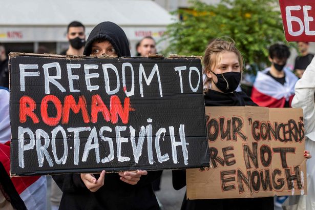 Belarusians living in Poland and Poles supporting them hold up a placard reading 'Freedom to Roman Protasevich' during a demonstration