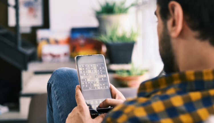person playing brain training game on smartphone
