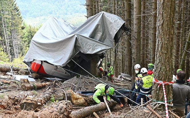 Carabinieri and Soccorso Alpino forces inspect the site where the Stresa-Alpino-Mottarone cable car crashed to the ground