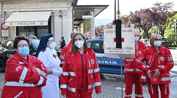 People gathered as Father Gianluca Villa, parish priest of Stresa, held an act of remembrance for those who died