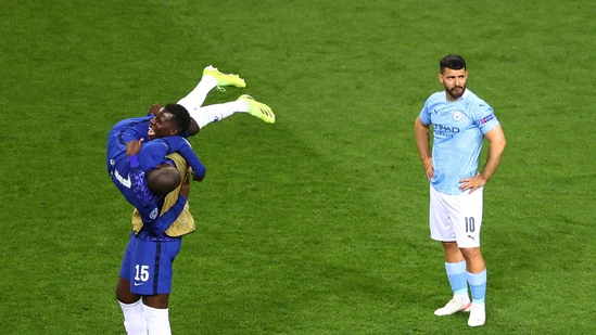Chelsea players celebrate after winning the Champions League as Manchester City's Sergio Aguero looks dejected.(Pool via REUTERS)