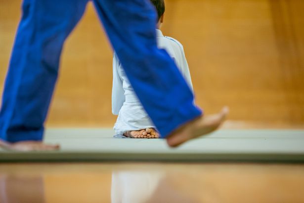 The teacher slammed the boy into the mat (stock image)