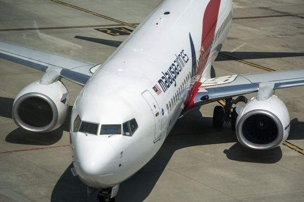 A Malaysia Airlines jet similar to missing MH370 is seen on the tarmac at Kuala Lumpur International Airport