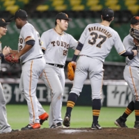 Yomiuri players celebrate after their win against the Hawks on Sunday in Fukuoka. | KYODO