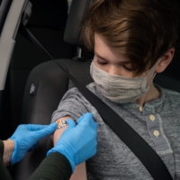 A health worker administers a COVID-19 vaccine on May 13 in East Hartford, Connecticut. Immunity to the coronavirus lasts at least a year, possibly a lifetime, improving over time especially after vaccination, according to two new studies. | CHRISTOPHER CAPOZZIELLO / THE NEW YORK TIMES